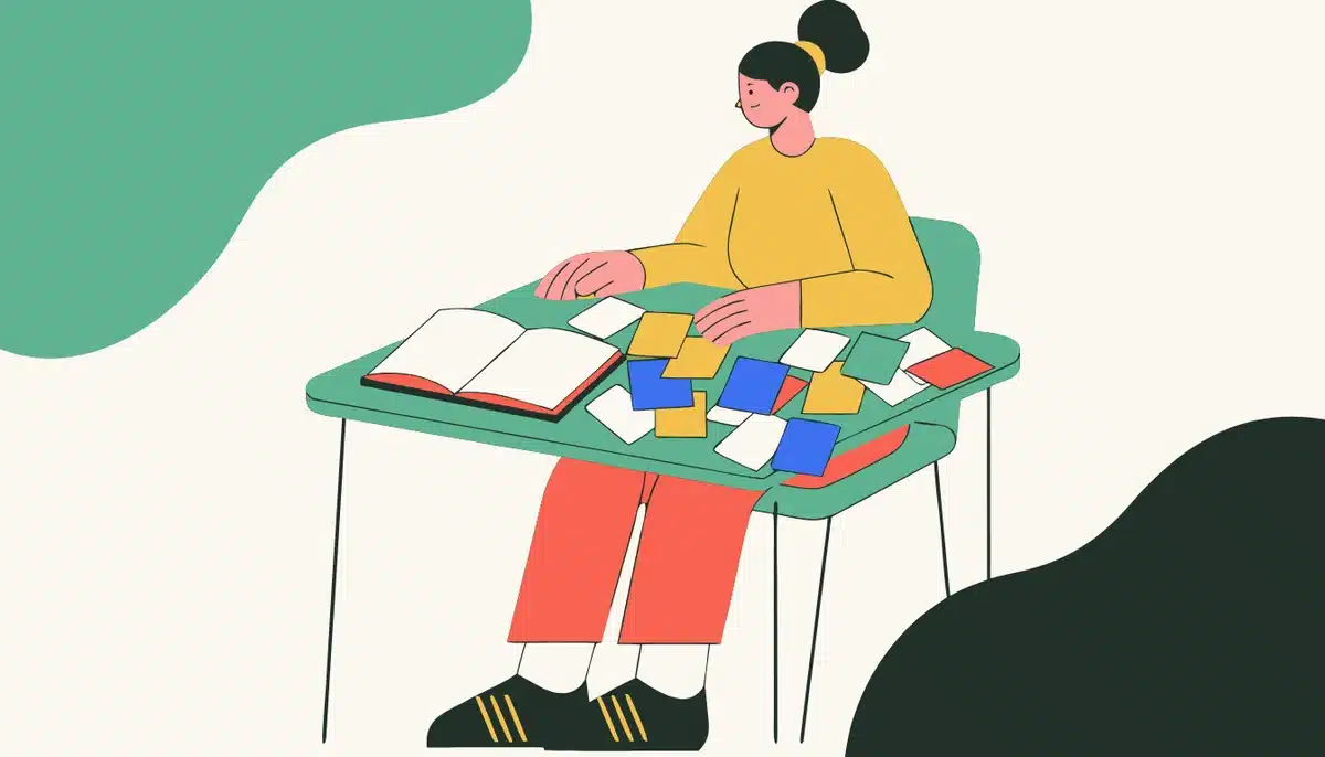 Effektives Vokabeltraining: Die besten Methoden, um nie wieder neue Wörter zu vergessen 1 Illustration: Eine Lernerin mit bunten Karteikarten am Schreibtisch.